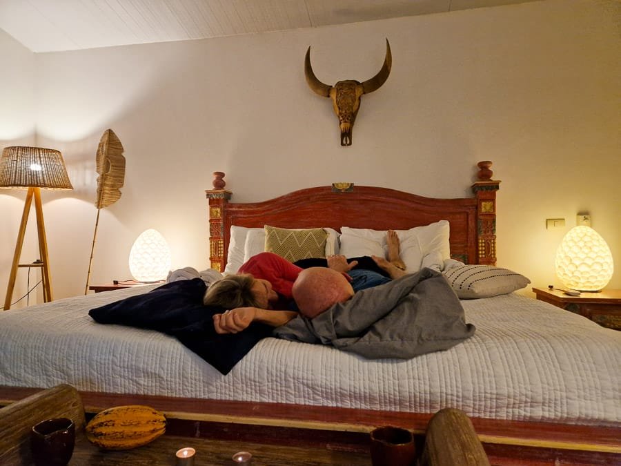 Couple in bed enjoying a private sound journey in their villa during tantra and intimacy retreat