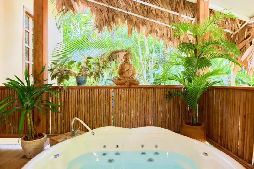 Private jacuzzi surrounded by tropical greenery at the Pranamor retreat accommodation
